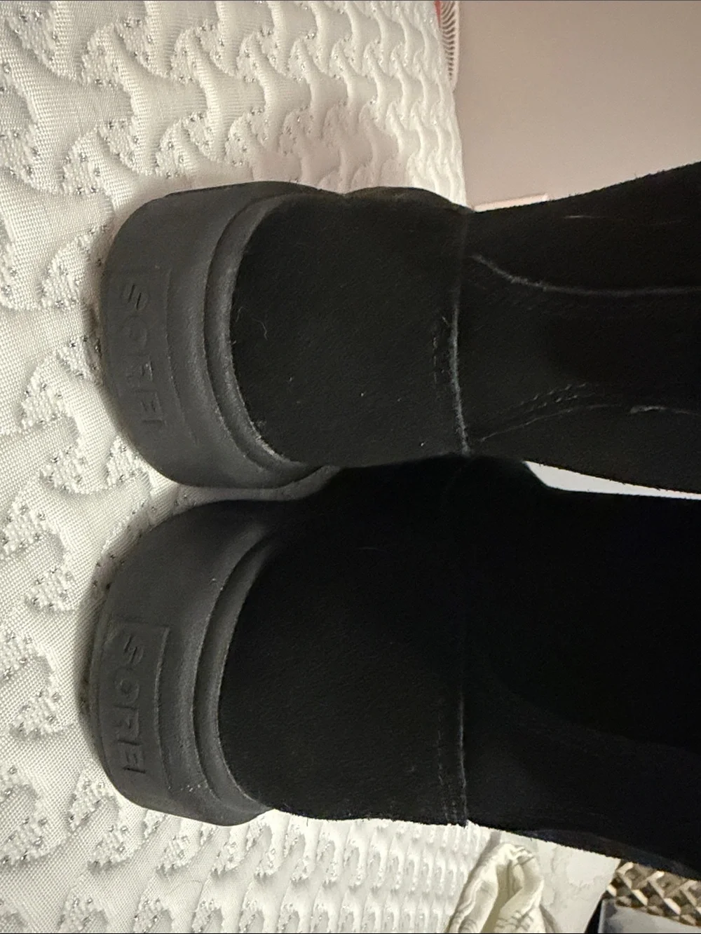 The image shows a pair of black SOREL Women's Explorer III Slip-On waterproof